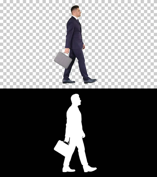 Hombre de negocios guapo en un traje camina con un maletín, Alpha Cha —  Fotos de Stock
