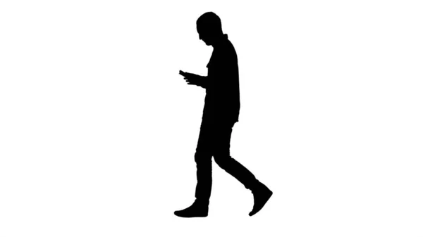 Silhouette Confident serious man walking and working in tablet. — Stock Photo, Image