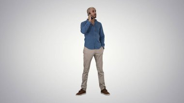 Arabic man talking on the phone on gradient background. clipart