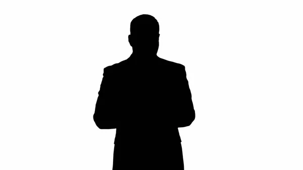 Silhouette Man in suit walking and using digital tablet. — Stock Photo, Image