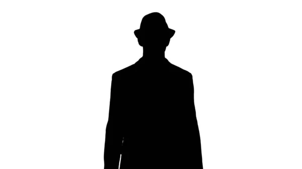 Silhouette Homme arabe décontracté marchant dans un chapeau et avec une mallette. — Photo