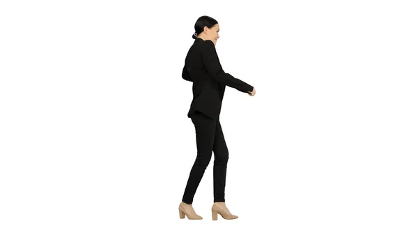 Smiling young business woman doing a cheerful walk on white back — Stock Photo, Image
