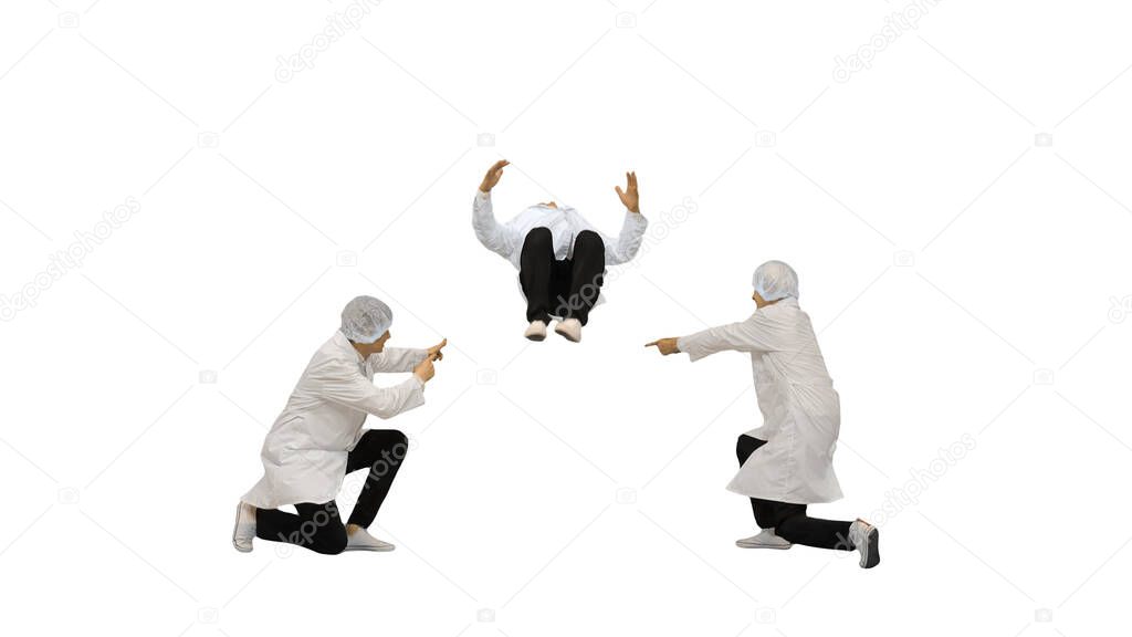 Three male doctors in white robes and protective caps doing sync