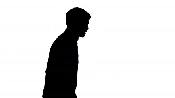 Silhouette Exhausted young man suffering from heat while walking. — Stock Video