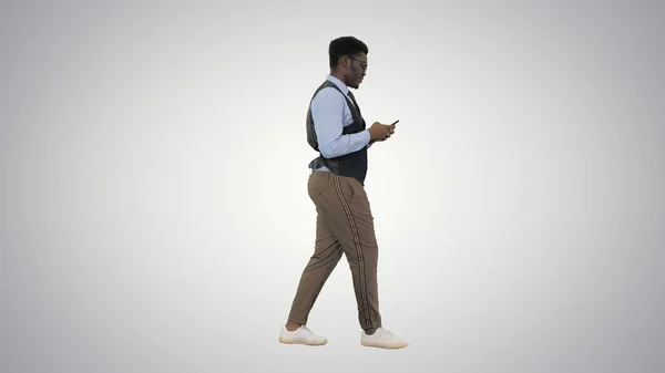 Boldog fiatal afro-amerikai üzletember sétál és SMS-ezik — Stock Fotó