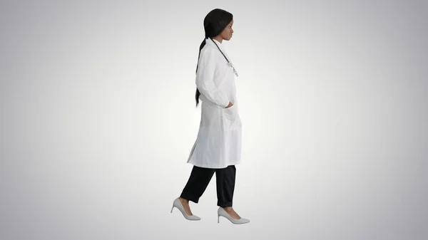 Sad African american female doctor walking with hands in her poc — Stock Photo, Image