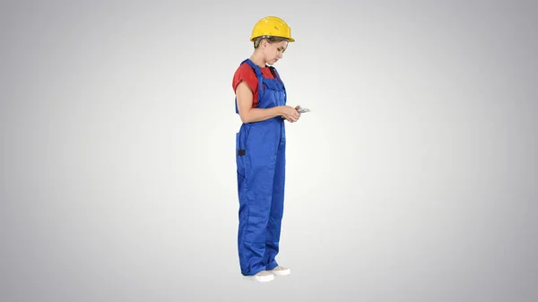 Happy young constructor counting her money on gradient backgroun — Stock Photo, Image