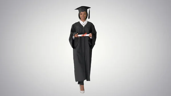Serious African American female graduate walking with diploma on — Stock Photo, Image