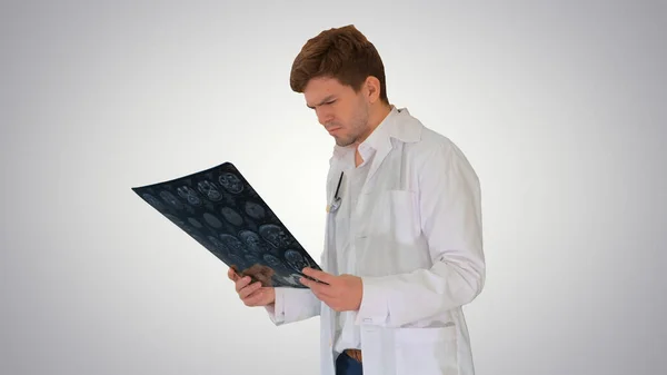 Concentrated male doctor looking at computed tomography xray ima — Stock Photo, Image