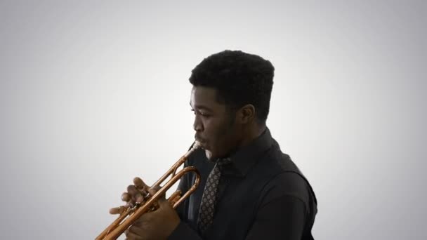 Músico afro-americano tocando trompete expressivamente em fundo gradiente. — Vídeo de Stock