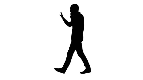 Silhouette Uomo che parla al telefono, cammina e fa gesti. — Foto Stock