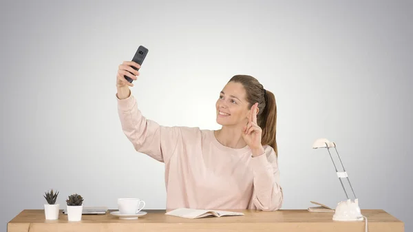 Piękna kobieta robi sobie selfie z telefonu komórkowego siedzi w t — Zdjęcie stockowe
