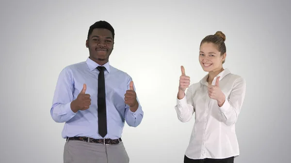 International happy smiling man and woman showing thumbs up on g — Stock Photo, Image