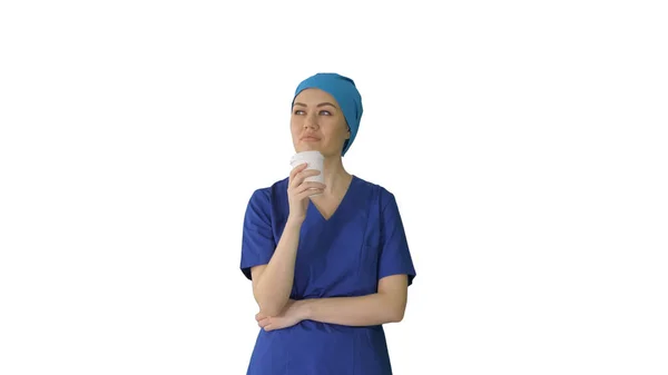 Smiling female doctor or nurse in blue uniform having a coffee b — Stock Photo, Image