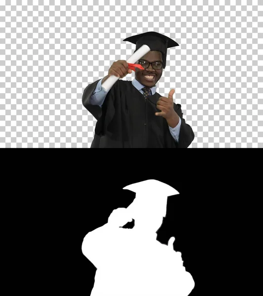 Excited african american male student in graduation robe waiving