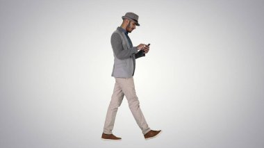 Mezun olurken akıllı telefon kullanan ciddi bir Arap adam.