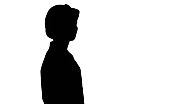 Silhouette Junge Frau mit Bollenhut geht und schaut sich um. — Stockfoto