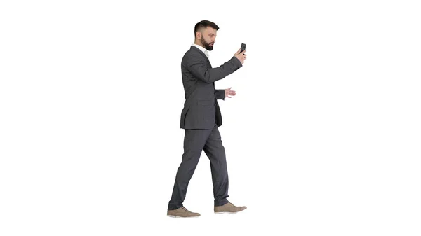 Handsome businessman walking and recording vlog on his phone on — Stock Photo, Image