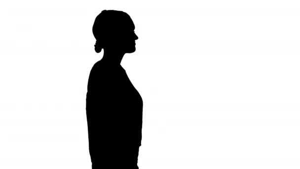Silhouette Young woman with headphones walking listening to the music. — Stock Video