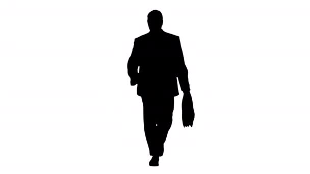 Silhouette Maduro hombre de negocios caminando con prisa y mirando el reloj. — Vídeos de Stock