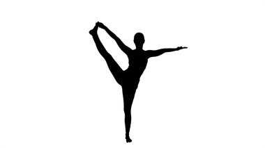 Siluet Genç kadın yoga yapıyor, Utthita Hast 'ta duruyor.