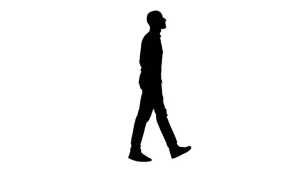 Silhouette Selbstbewusst in seinem Stil Modell walkin mit den Händen in den Taschen. — Stockfoto