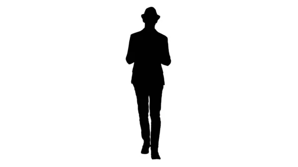 Silhouette Casual man in a hat walking and showing digital tablet to camera. — Stock Photo, Image