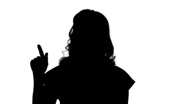 Silhouette Giovane donna caucasica che punta con mano e dito t — Foto Stock