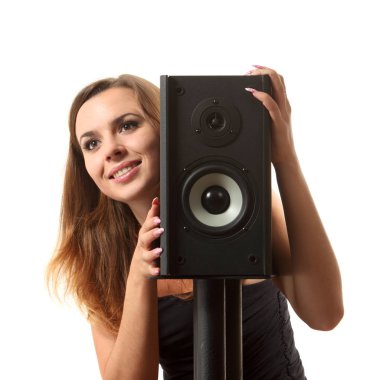 Beyaz izole arka planda bir hoparlör yakınındaki bir genç kız