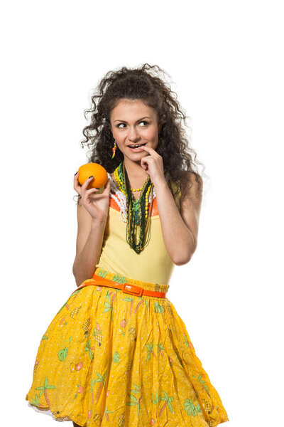 Young attractive girl with orange  isolated on the white background