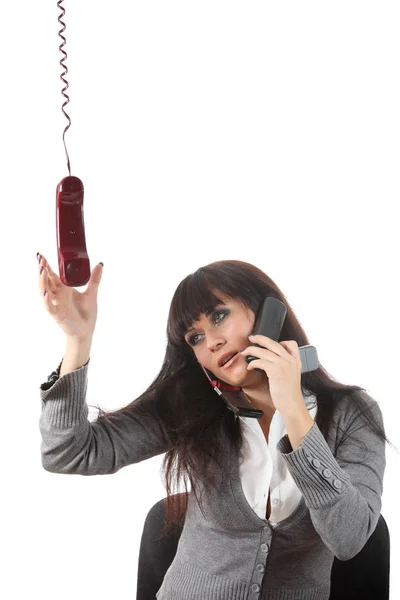 実業家が彼女のワークスペースで同時に つの携帯電話で話す — ストック写真
