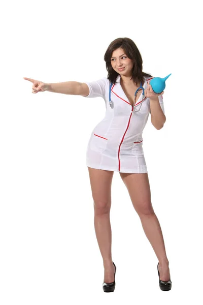 Νέα Ελκυστική Νοσοκόμα Κρατώντας Κλύσμα Και Δείχνει Αριστερά — Φωτογραφία Αρχείου
