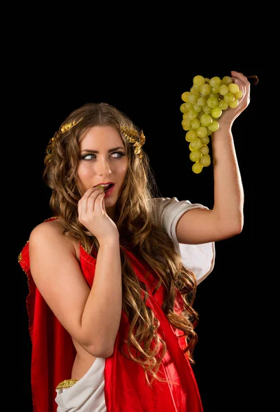 Ancient goddess with a bunch of grapes isolated on a black background