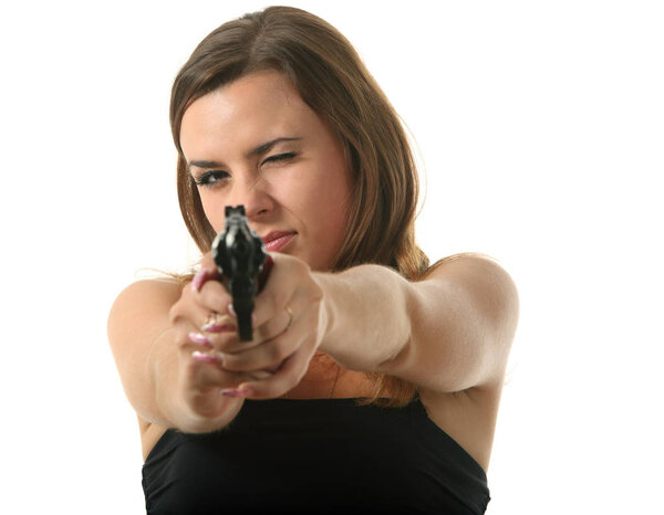Beautiful young girl is aiming a revolver