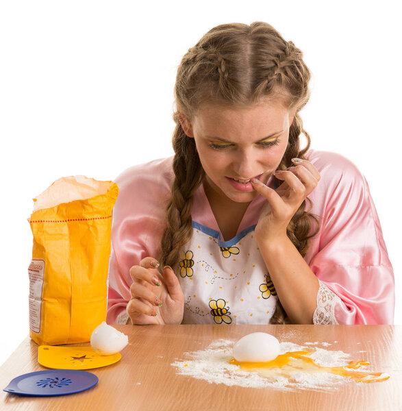 Awkward blonde cooking  in the kitchen