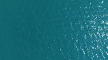 Üstten görünüm, ağır çekim. Mavi deniz, mavi lagün hafif bir esinti, küçük dalga ile arka plan.