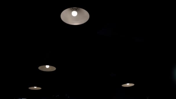 Ceiling with built in halogen lamps, switching on slowly in darkness. — Stock Video