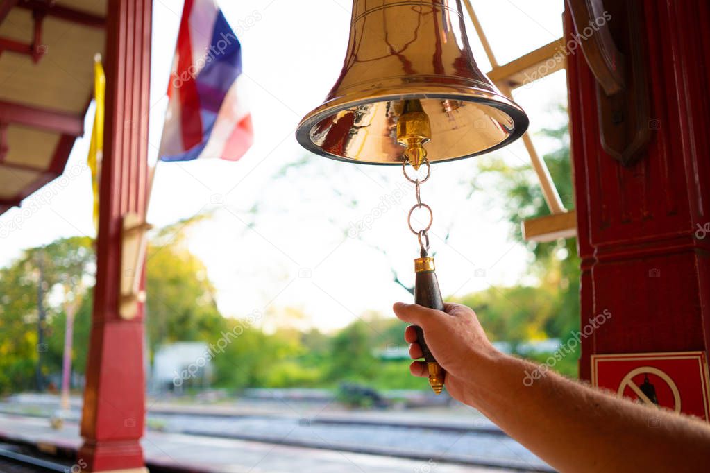Hand rings the bell. Male hand is ringing the bell.
