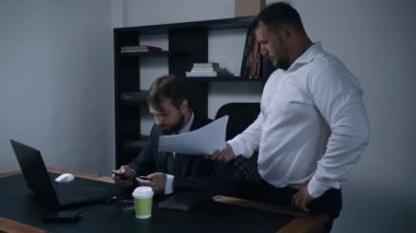 iki işadamı belgeleri ofiste, Şef bir sözleşmenin imzalanması hakkında tartışmak ve bağımlı, adam belgeleri, yavaş atar