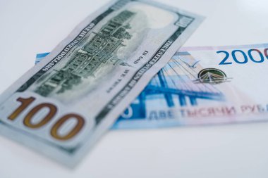 Amerikan 100 dolarlık banknot ve 2000 Rus ruble. Kavram Ticaret, işbirliği veya güreş.