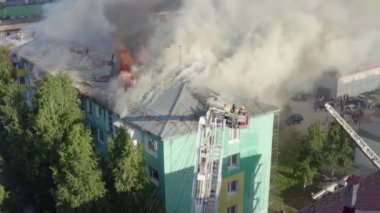 Nizhnevartovsk, Rusya - 1 Temmuz 2019: İtfaiyeciler bir konut yüksek binanın çatısında bir yangın söndürmek. üst görünüm