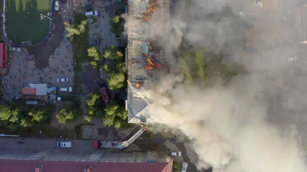 Burning roof of a residential high-rise building, clouds of smoke from the fire. top view