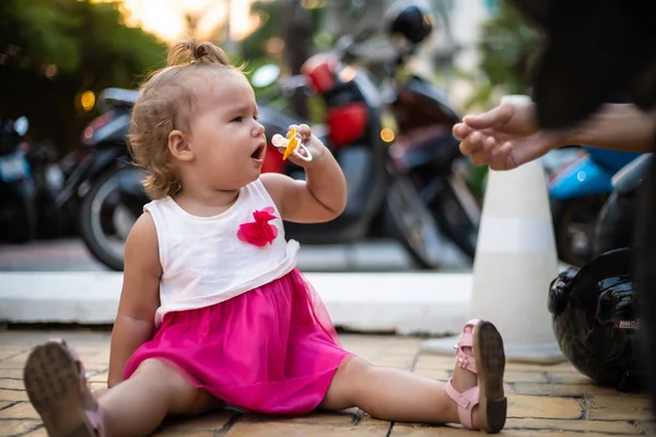 An older child being given a pacifier by an adult. — Stock Photo, Image