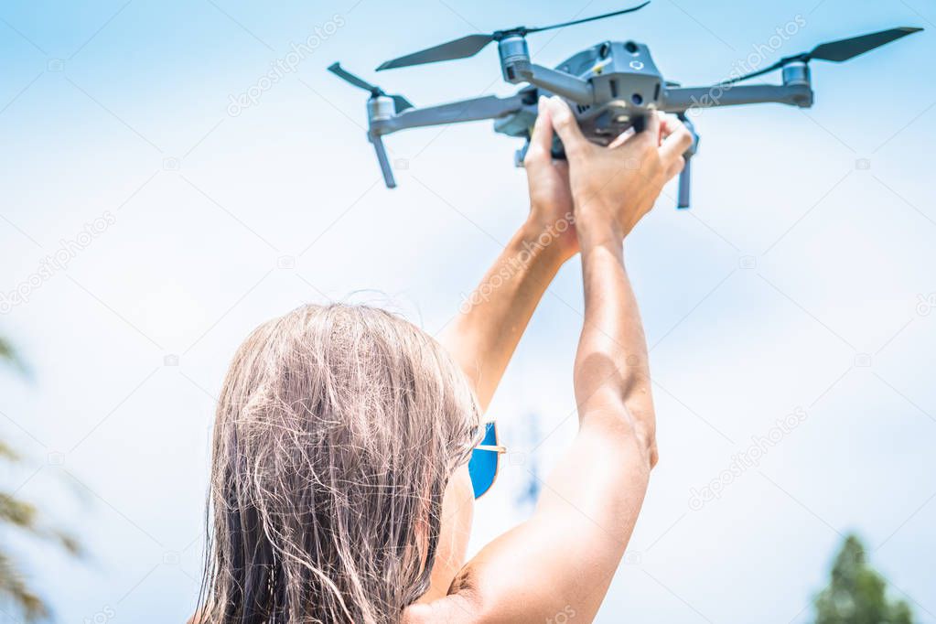 Female hand launches drone for flight, with which you can take photos and video filming, close-up