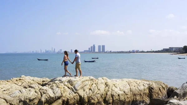 Couple walking near sea. Couple walking on a cliff by the sea.