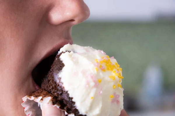 La bocca femminile morde la torta. Torta. Primo piano — Foto Stock