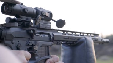 Adamın elinde ki tüfek. Bulanık Doğa Arka Planda Yakın Çekim Görünümü ile Silahın Ön Yüzü