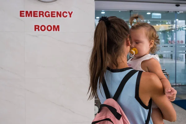 Mom and child come in in the emergency room at the hospital in Pattaya Thailand.