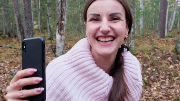 Rire femme en automne forêt parler sur téléphone sur skype . — Video