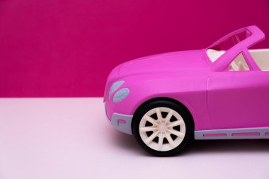 Pembe arka planda pembe bir araba. Araba satışı, araba kiralama veya araba kiralama kavramı.